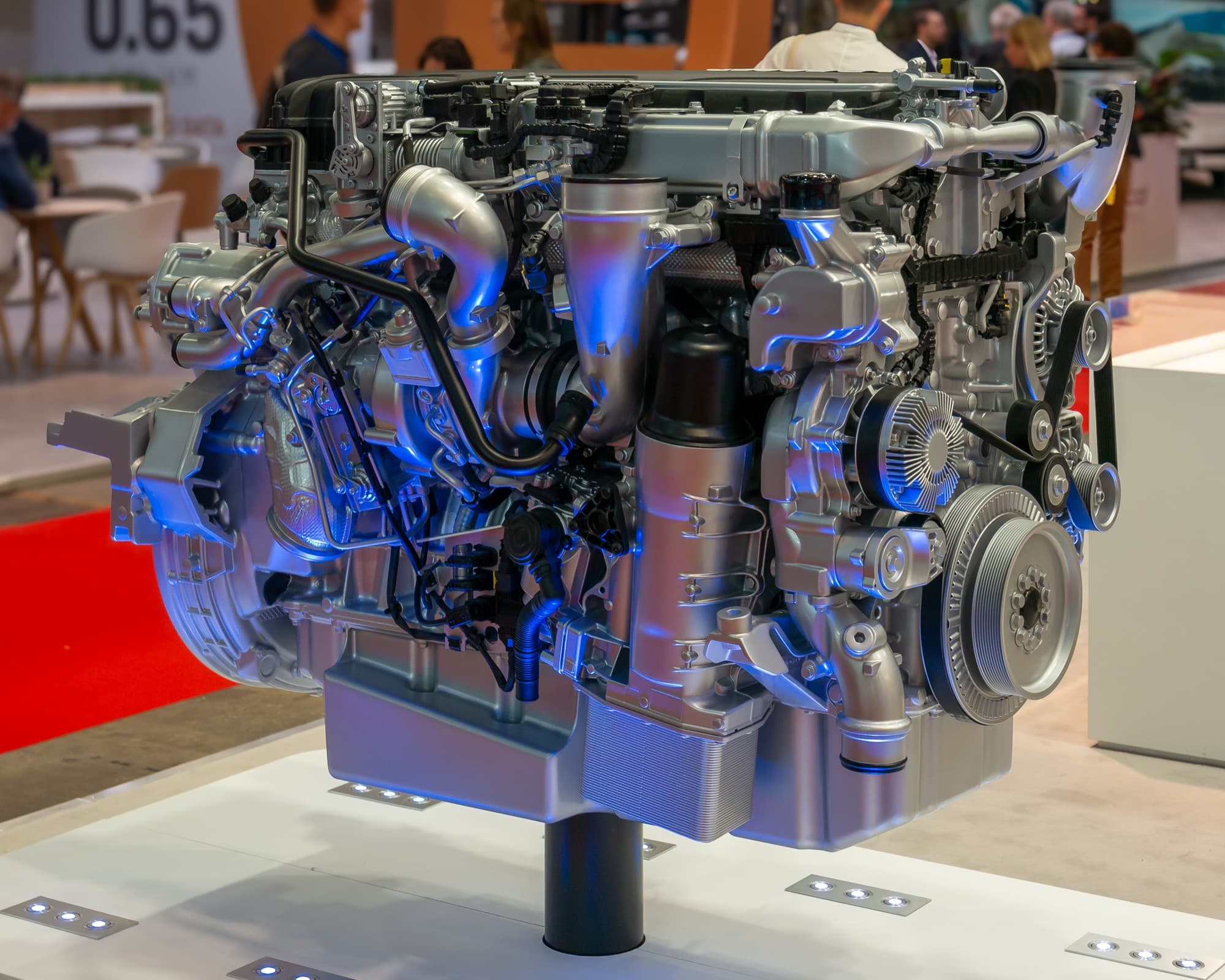 A complete six-cylinder truck diesel engine showing its turbocharger, filters and pulleys.